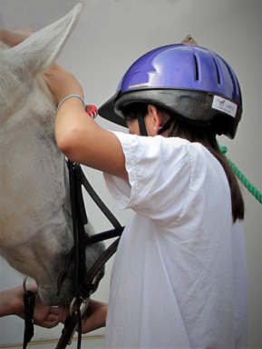 student having lesson on right way to apply horse's bridle
